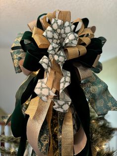 a close up of a christmas tree with ribbons on it