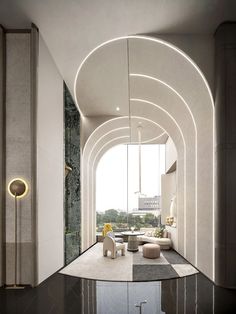 the interior of a modern living room with curved walls and floor to ceiling glass windows