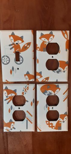 three decorative switch plates with foxes on them