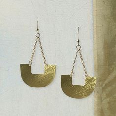 Both subtle and dramatic simultaneously. These brass semi-circle drop statement earrings easily add punch your outfit. They have a brushed finish for a modern sensibility, although we think there's a hint of a tribal design in there. They're one of those basic designed pieces you can't pigeon hole and that makes these earrings so wonderfully versatile. Details: Semi-circle drop statement earrings with hook back suitable for pierced ears. Size: Length of drop: ~ 3" (7.6 cm), width of widest part: ~1.4" (3.5cm) Material: Brass Pigeon Hole, Statement Drop Earrings, Pierced Ears, Pigeon, Ear Piercings, Statement Earrings, Handmade Jewelry, Drop Earrings, Brass