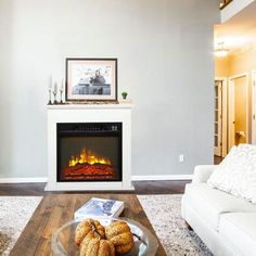 a living room with a fire place and couches