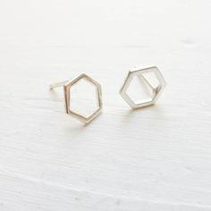 "Dainty sterling silver hexagon honeycombs are soldered to sterling silver studs to create these minimal earrings. . { m e a s u r e m e n t s } . ~ 1/3\" . { o p t i o n s } . Other Post Earring Styles: https://www.etsy.com/shop/CamileeDesigns?section_id=10245147&ref=shopsection_leftnav_3 . { p a c k a g i n g } . Your jewelry will arrive in a cute box - perfect for giving or keeping for yourself. . { s h i p p i n g } . Handmade in my studio and shipped via USPS mail with tracking. Please Minimalist Silver Octagon Jewelry, Modern Sterling Silver Hexagon Jewelry, Minimalist Sterling Silver Octagon Jewelry, Minimalist Octagon Sterling Silver Jewelry, Minimalist Hexagon Sterling Silver Jewelry, Minimalist Hexagon Faceted Jewelry, Honey Combs, Earring Styles, Minimal Earrings