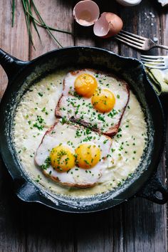 three eggs are on top of some sort of meat in a skillet