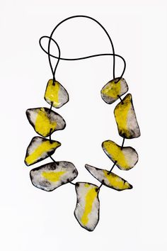 Mixed-Media Necklace - A double necklace, handcrafted from strong, synthetic paper coated with resin featuring a symphony of contrasts! The front showcases radiant yellow and white, while the back captivates in abstract in black and white, creating a layered, collage effect. Connected by a supple rubber cord, the necklace exudes both elegance and boldness. No clasp. Modern Handmade Yellow Jewelry, Layered Collage, Mixed Media Necklace, Abstract Necklace, Porcelain Necklace, Double Necklace, Paper Earrings, Jewelry Knots, Professional Gifts