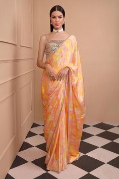 Yellow digitally printed silk satin saree in a delightful yellow hue, pink highlights and embroidered border. Paired with embroidered blouse and satin petticoat.
Components: 3
Pattern: Embroidered, Printed
Type Of Work: Geometric
Neckline: Square
Sleeve Type: Sleeveless
Fabric: Saree - Silk Satin, Petticoat- Satin, Blouse- Dupion
Color: Yellow
Other Details: 
Back deep neck
Embroidered detailing
Model height: 5ft 8inches, wearing size XS
Occasion: Wedding - Aza Fashions Saree Silk, Yellow Saree, Pink Highlights, Satin Saree, Embroidered Border, Blouse For Women, Yellow Print, Square Print, Satin Blouse