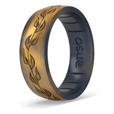 an engraved ring with gold leaves on it