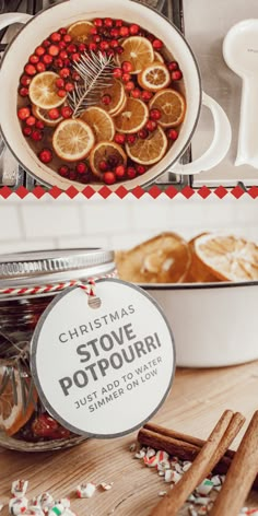 christmas potpour in a glass jar with cinnamons and orange slices