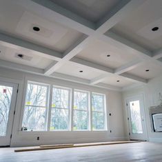 an empty room with white walls and windows