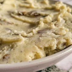 a bowl filled with mashed potatoes on top of a table