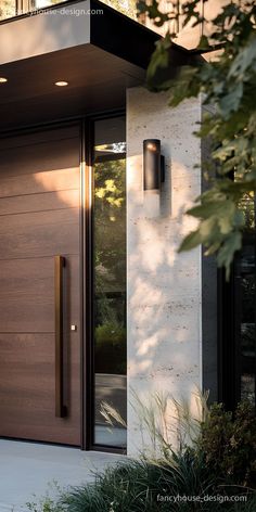 the front door to a modern house with glass and wood