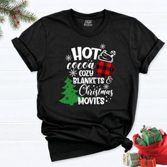 Hot Cocoa Cozy Blankets Shirt, Christmas Movies Shirt, Snowflake Christmas t-shirt, Christmas Shirt, Coffee Shirt, Christmas Tree Shirt. HI! Welcome to my store, I'm delighted to see you here. My store's main goal is to provide you with premium everyday apparel with the best graphic t-shirts. I see you as a friend, not just a customer. I'm sure you'll love my designs. So, here is a brief description for you to-see-the order-process: 1. Please, Check and Review all Photos. 2. Select Your T-Shirt Winter Gift Shirt With Letter Print, Winter Letter Print Shirt For Gift, Winter Letter Print Shirt Gift, Cozy Cotton Christmas Tops, Black Shirt For Winter Holiday, Cotton T-shirt For Winter Gift, Festive Winter T-shirt With Short Sleeves, Festive Short Sleeve T-shirt For Winter, Winter Holiday Short Sleeve Shirt