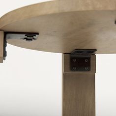 a close up view of a wooden table with two metal brackets on the top and bottom