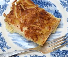 a piece of cake on a blue and white plate with a fork