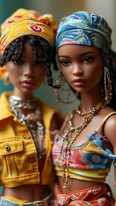 two dolls are posed next to each other wearing head scarves and bandannas