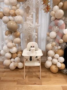 a baby's high chair in front of balloons