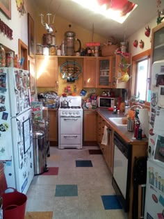 a kitchen filled with lots of appliances next to a stove top oven and refrigerator freezer