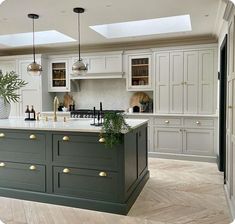 a large kitchen with an island in the middle and lots of cabinets on both sides