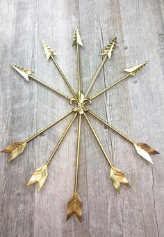 a gold clock with many arrows on it