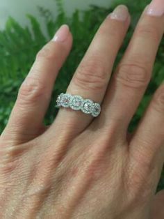 a woman's hand with two diamond rings on her left and the other hand