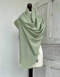 "It is made of a soft cotton fabric, which gives it a sage green color. You will look very elegant wearing this bridal tassel shawl. The pale green pashmina scarf makes for a brilliant and priceless gift.  Several ways can be used to wrap this long wrap around your neck, such as wrapping it twice or in one long wrap. This pashmina scarf is made of soft and quality cotton fabric. Are you looking for a unique gift for your maid of honor? For your bridesmaid or mother of the bride, this long sage g Green Shawl, Groom Dress Men, Bridesmaid Shawl, Mother Of The Bride Gift, Bridal Cover Up, Dress Men, Sage Wedding, Sage Green Wedding, Bridal Shawl