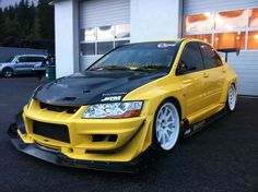 a yellow car parked in front of a building