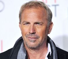 an older man with grey hair wearing a black jacket and scarf on the red carpet