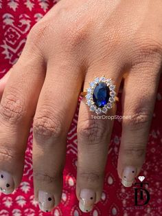 a close up of a person's hand with a blue ring on top of it