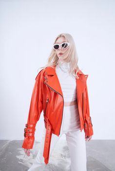 ORANGE ITALIAN LEATHER BIKER JACKET  An exotic orange modern Italian leather biker jacket, in super soft lambskin leather. This leather jacket features trendy yet chic double belted buckles to the waist and triple belted buckles to the cuffs. Its gorgeous fashionable detailing is further accentuated through shoulder epaulettes and additional zips and pockets. Spring Leather Biker Jacket With Belt Loops, Spring Biker Leather Jacket With Belt Loops, Biker Leather Jacket With Belt Loops For Spring, Edgy Leather Belted Biker Jacket, Belted Moto Leather Jacket, Trendy Spring Leather Jacket With Belt, Trendy Belted Leather Jacket, Trendy Belted Leather Jacket For Spring, Trendy Leather Biker Jacket With Belt