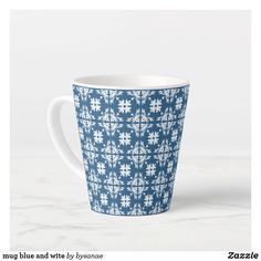 a blue and white patterned cup sitting on top of a table