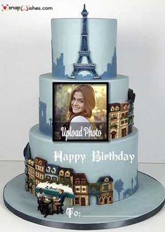 a birthday cake with the eiffel tower in the background and photos on it