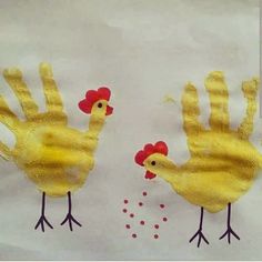 two handprints with yellow chickens on them and red dots in the bottom left corner