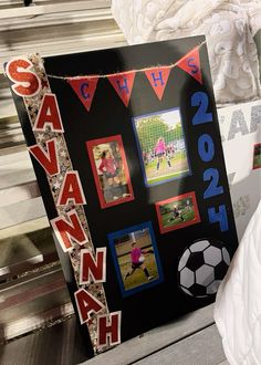 a sign with photos and words on it in front of a soccer goal, which reads savannah