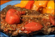 a blue plate topped with meat and vegetables