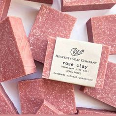 soap bars with pink flecks on top of each other and a label that says heavenly soap company