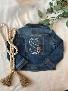 a denim jacket with the letter s on it