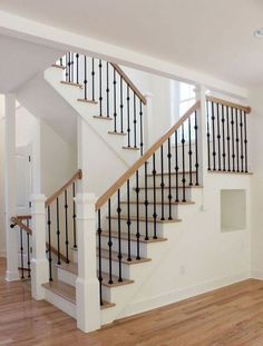 the stairs in this house are painted white and have black balconies on them