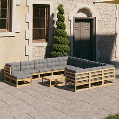 an outdoor patio with wooden furniture and potted plants on the side of the building