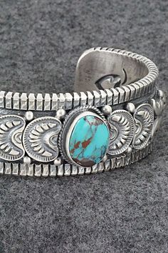 This beautiful and substantial turquoise and sterling silver bracelet was made by Navajo silversmith Roland Dixson. The inside is signed Roland Dixson and stamped sterling.Size: 5 3/8" (will fit up to a 6 3/4" wrist)Gap: 1 3/8"Length: 1"Free shipping on all orders! We ship with USPS and always include tracking. All orders ship within a day of payment.Returns are accepted up to 30 days after you receive your order. Just send us a message. Our shop offers cash back or store credit. The item must b Southwestern Etched Turquoise Jewelry, Southwestern Style Etched Turquoise Jewelry, Southwestern Turquoise Etched Jewelry, Handmade Southwestern Sterling Silver Bracelet, Southwestern Stamped Turquoise Sterling Silver Bracelet, Southwestern Style Sterling Silver Turquoise Bracelet, Southwestern Turquoise Stamped Sterling Silver Bracelet, Southwestern Style Stamped Turquoise Bracelets, Southwestern Style Turquoise Stamped Bracelets