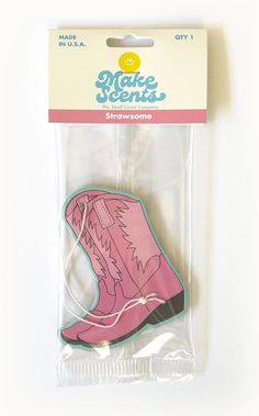 a pink shoe shaped magnet on top of a package