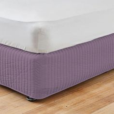 a bed with a purple mattress on top of it