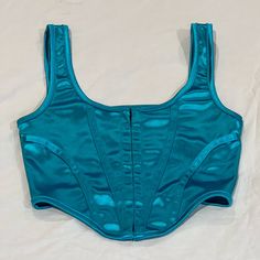 Urban Outfitters Motel Elix Bustier Corset Top Teal Xs -Size Xs, Brand New Preloved Condition -Retails For $54 -New Condition Only Worn Once Or Twice And It’s Been Washed :) -Measurements: Pit To Pit 12", Shoulder To Hem 14" Orders Ship Within 1-2 Business Days. Feel Free To Send Offers And Ask Questions! All Offers Are Considered! Thanks For Checking Out My Closet & Happy Shopping! No Trades, Refunds, Exchanges Or Returns. Everything Is Final Sale. Am Not Responsible For Any Packages Lost In Tr Blue Crop Top With Built-in Bra And Tank Straps, Fitted Blue Crop Top With Built-in Bra, Blue Camisole Crop Top With Straps, Fitted Satin Crop Top, Blue Fitted Sleeveless Crop Top, Fitted Camisole Crop Top With Corset Back, Fitted Corset Back Camisole Crop Top, Supportive Summer Tops, Blue Sleeveless Corset With Straps