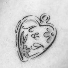 a heart tattoo with flowers on it