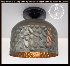 a close up of a light fixture with a quote above it that says, why would i lead by foot and a light my way?