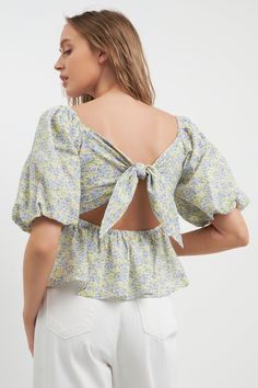 Elevate your everyday style with this pretty tie back top. Blooming with floral charm, this top is perfect for dressing up or down. The tie detail at the nape of the neck adds a touch of elegance, while the puff sleeves keep it feeling fun and flirty. Whether you're meeting friends for lunch or out on a date night, this top is sure to elevate your look. Floral print Tie detail at back Puff sleeves Sweet heart neckline Hand wash cold Do not bleach Do not tumble dry Iron low Shell: 100% Cotton Lin Summer Puff Sleeve Blouse For Garden Party, Feminine Puff Sleeve Tops For Garden Party, Spring Garden Party Tops With Puff Sleeves, Spring Garden Party Puff Sleeve Tops, Trendy Tops For Spring Garden Party, Puff Sleeve Blouse For Garden Party, Summer Puff Sleeve Top With Tie Sleeves, Green Tie Back Top For Day Out, Chic Spring Puff Sleeve Top With Tie Sleeves