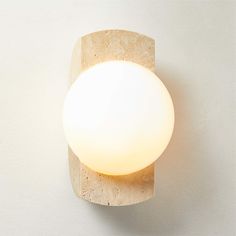 a light that is on the wall next to a white wall and flooring area