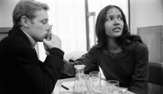 a man and woman sitting at a table