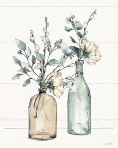 two glass vases with flowers in them