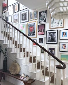 there is a staircase with pictures on the wall