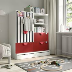 a child's room with toys, bookshelf and dresser in white and red