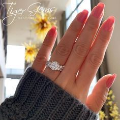 a woman's hand with a diamond ring on it